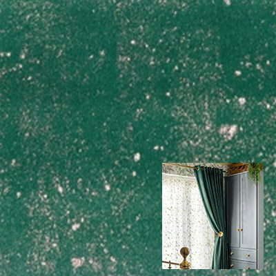 Green velvet curtain fabric with a soft, textured finish, draped in a modern interior setting.